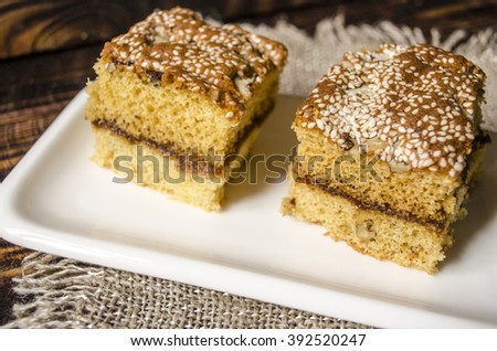 Sliced biscuit cakes from nuts and sesame seeds on a white porcelain plate
