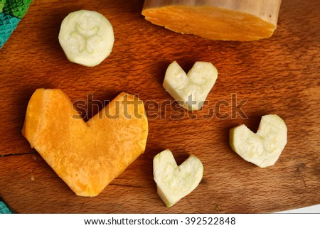 cut pumpkin and courgette in heart form image as food stylish decoration to valentines day dinner