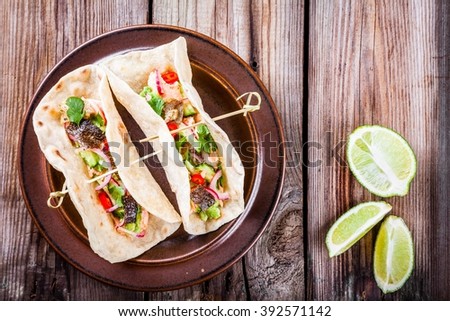 homemade tacos with salmon, onion, cucumber and avocado