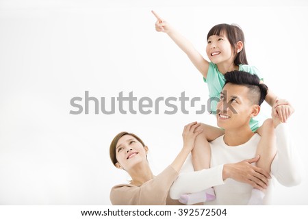 Happy family looking away and pointing Royalty-Free Stock Photo #392572504