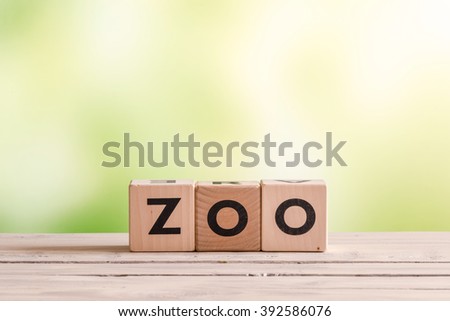 Zoo sign made of wood on a green background
