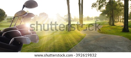 Golf clubs drivers over  beautiful golf course at the sunset, sunrise time. Royalty-Free Stock Photo #392619832