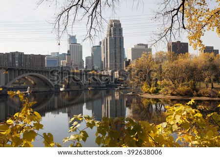 Minneapolis Minnesota skyline with Nicollet Island. Fall city skyline with yellow leaves in the foreground.