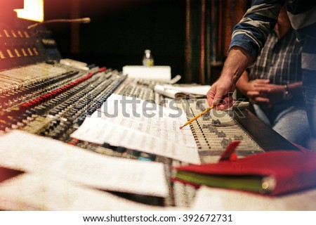 Music studio. Orchestrating record music album. Vintage old look with scratches and worn out retro look Royalty-Free Stock Photo #392672731
