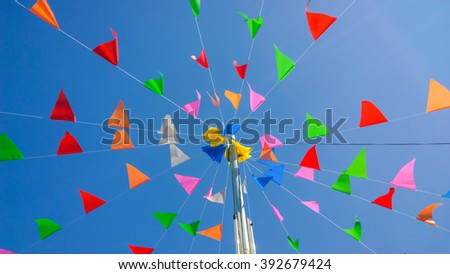 colored paper hanging from a rope on sky 