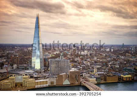 England - Skyline of South London with London Bridge, Shard skyscraper and River Thames - United Kingdom with beautiful golden sky Royalty-Free Stock Photo #392705254