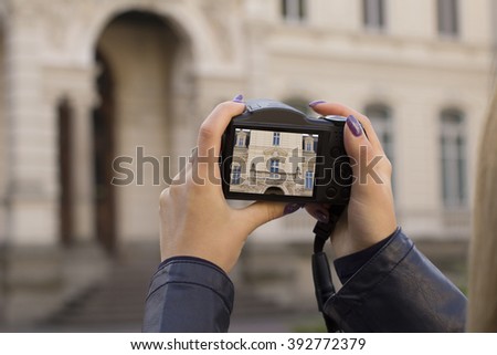 Woman tourist taking picture on the camera. Closeup shot