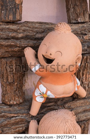 close-up,funny clay doll on a wooden ladder from my home,process color