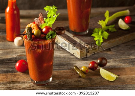 Homemade Bacon Spicy Vodka Bloody Mary with Tomatos, Olive and Celery Royalty-Free Stock Photo #392813287