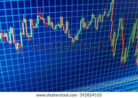 Stock market graph on the screen. Display of quotes pricing graph visualization. Financial diagram with candlestick chart. New modern computer and business strategy as concept. 
