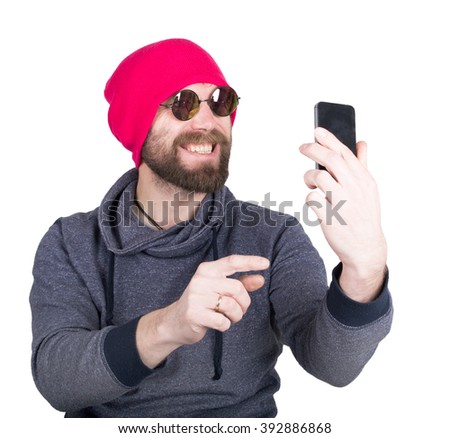 Fashion hipster cool man in sunglasses and colorful clothes holding a phone in front of him and pictures of themselves, selfie. isolated on white background