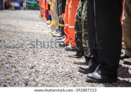 The fire departments and emergency response teams will conduct disaster preparedness drills. This group of team members gathers around to discuss options,selective focus. Royalty-Free Stock Photo #392887153