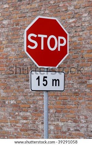 Stop sign cautioning drivers to stop in 15 meters