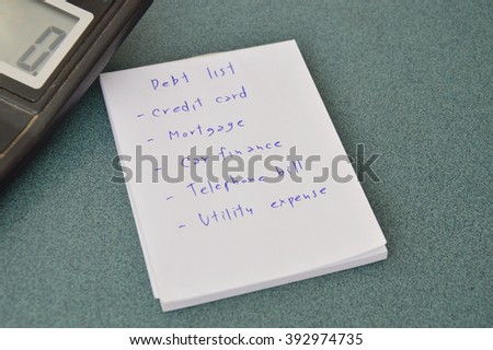 debt list and calculator on table