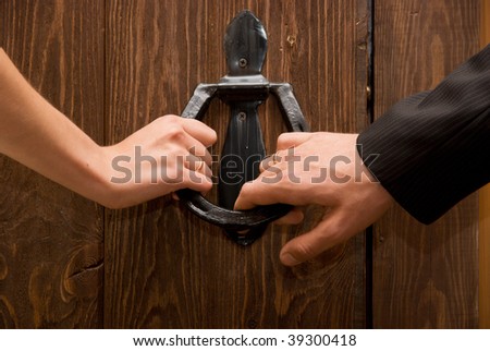 Close up of just married hands opening the door together