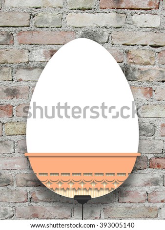 Close-up of one hanged decorated Easter egg blank frame with clip against grey brick wall background