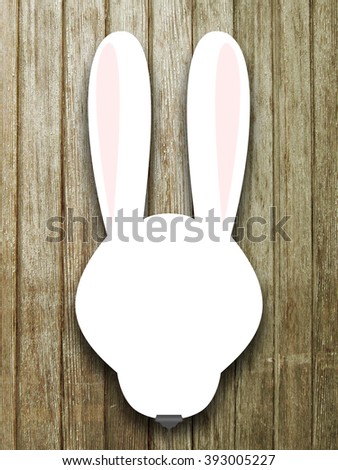 Close-up of one hanged blank rabbit silhouette frame with clip against brown weathered wooden boards