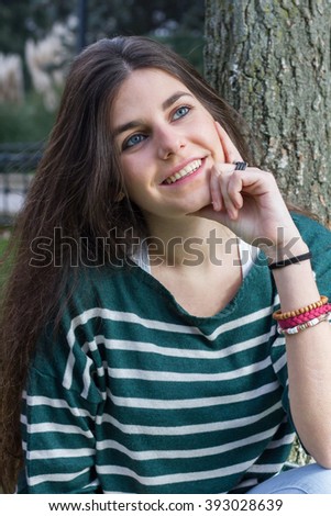 Blue-eyed young model posing in a fashion shoot in the park.