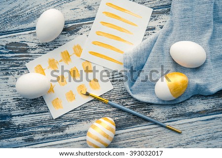 Modern easter eggs painted in gold. Toned picture
