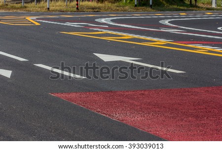 Arrow symbol on a black asphalt road surface
