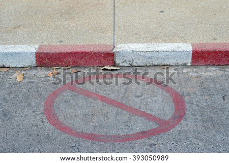 No Parking sign painted on concrete road. select focus and closeup with blur background.