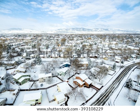 Fort Collins cityscape - aerial  view of typical residential neighborhood along Front Range of Rocky Mountains in Colorado, late winter  or early spring scenery with snow.
