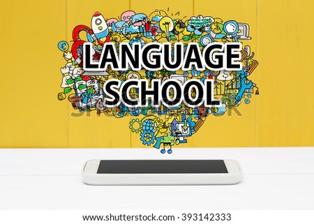 Language School concept with smartphone on yellow wooden background