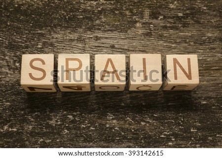 Word SPAIN on a wooden background