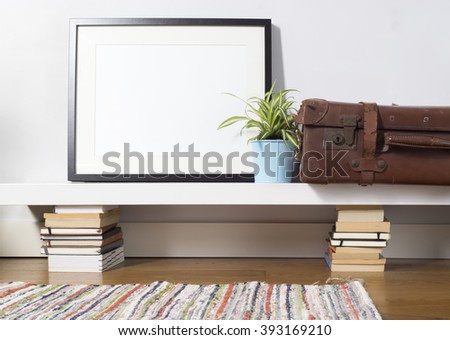 Black picture frame sitting on a white shelf