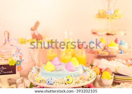 Dessert table with Easter cake decorated with traditional Easter marshmallow chicks.