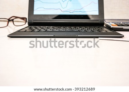 Black laptop on white table in office