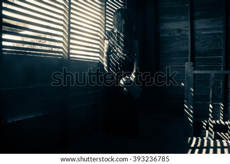 Ghost girl in haunted house,Mysterious girl in black dress standing in abandon house