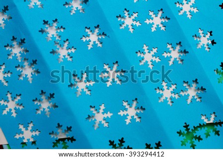 carved snowflake on blue  paper
