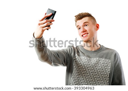 young casual man making selfie isolated on white