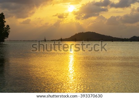 Abstract background of silhouette image sunset at lake in evening:Ideal use for background:Unfocused image.