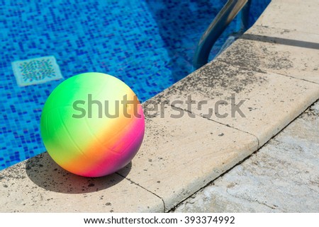 colored ball by the pool in the summer