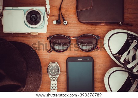 travel Items photo camera, wallet , Watches, headphones, shoes, sunglasses, smartphone for vintage background