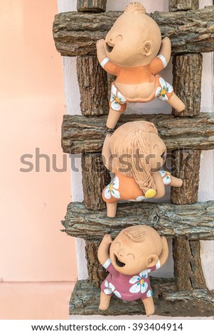 close-up,Three clay doll on a wooden ladder from my home,process color