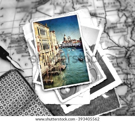 photograph with selective color  from the Grand Canal of Venice with the famous landmark cathedral Santa Maria della Salute laying on a desk with several images and a journal with pencil