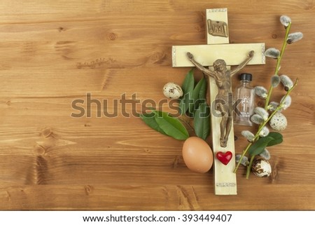 The Christian celebration of Easter. Holy Cross with Christ on a wooden background. Symbol of faith.