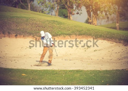 Golfers hit the ball in the sand. Speed and Strength.Vintage Color