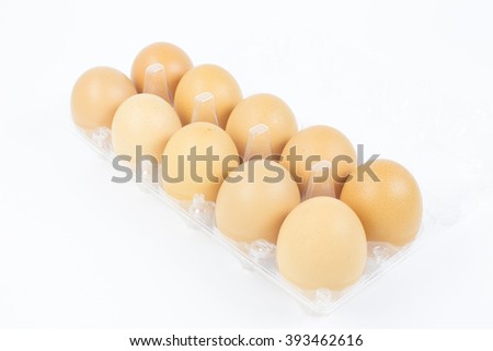 Fresh eggs in a package on white background. Ten eggs in plastic box with white background. This picture about food, breakfast or lunch and farm content.