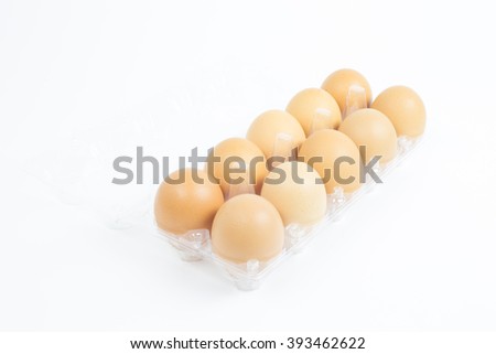 Fresh eggs in a package on white background. Ten eggs in plastic box with white background. This picture about food, breakfast or lunch and farm content.