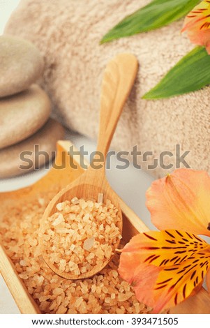 Spa still life with sea salt, towel and flower closeup