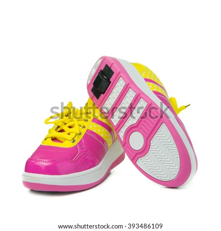 Pair of pink heelys on white background