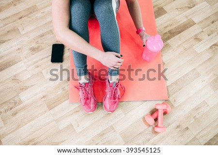Flat lay sport photography. Female athlete  relax after workout. Fitness flat lay photography of  coach after training. Girl drinks healthy protein shake after workout. 
