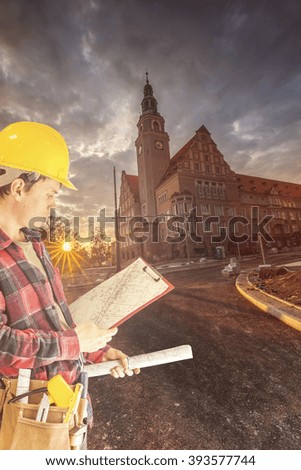 Construction manager on the construction site at sunset as background Construction