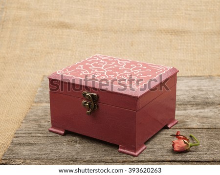 Painted, wooden small boxes for multiple purposes and jewels on a wooden surface                               