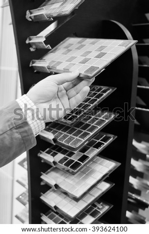 Black and white photography of hands choosing or presenting samples. Close up