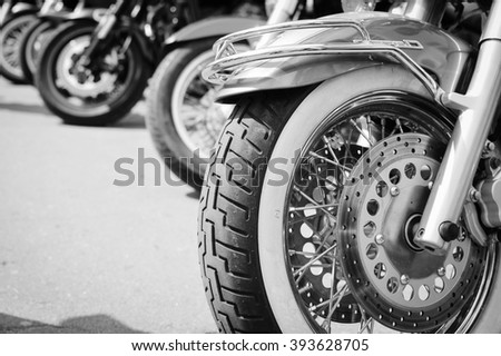 Black and white photography of group motorbikes parked together on outdoors background